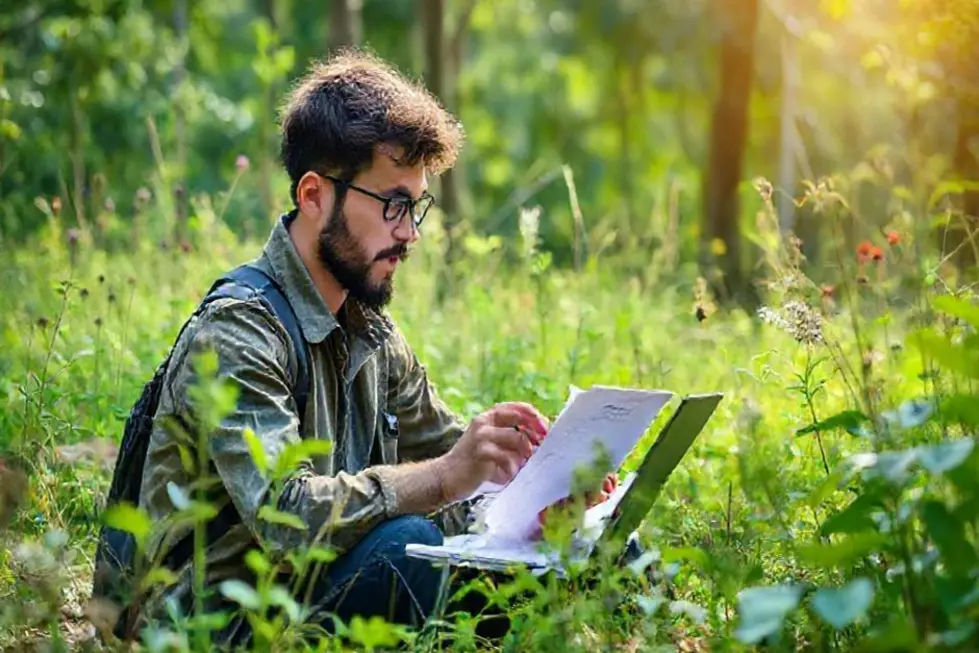 7 Estratégias para Escalar Seu Negócio Digital de Forma Sustentável - Web Nômade Digital Empreendedor em meio à natureza planejando um negócio sustentável.