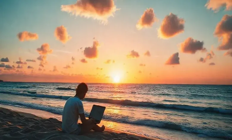 Pôr do sol sobre a praia com um nômade digital trabalhando.