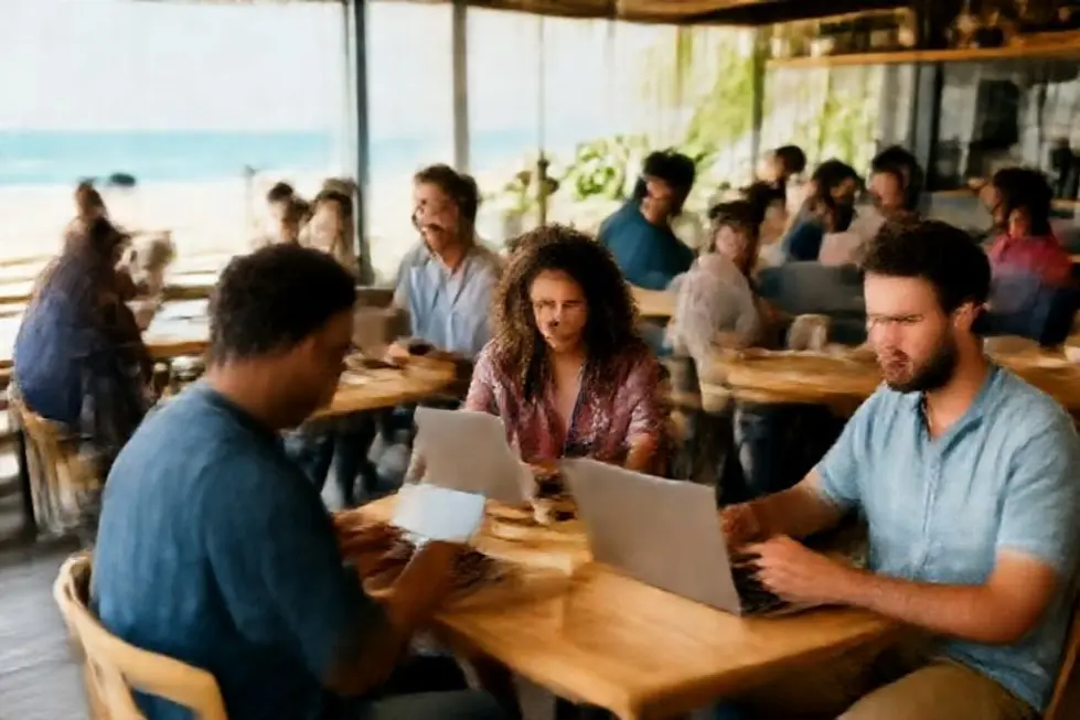 Um grupo diversificado de nômades digitais colaborando em diferentes locais, como cafés e praias.
