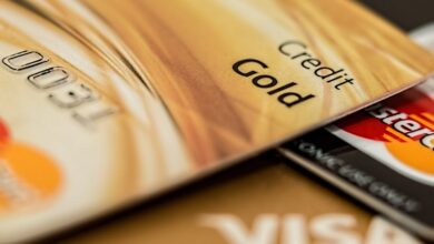 Stack of various branded credit cards focusing on gold card showing finance and cashless concept.