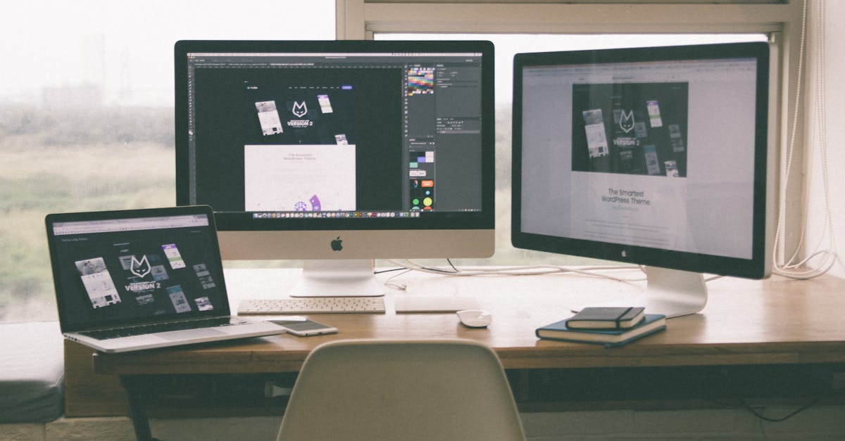 Stylish and efficient workspace with multiple monitors, laptop, and smartphone, showcasing a web design project.