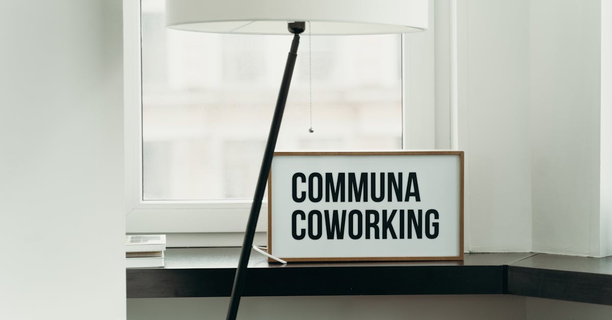 Simple and elegant coworking space decor with soft lamp lighting and window view.