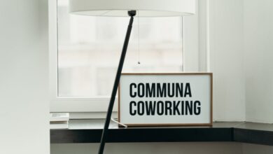 Simple and elegant coworking space decor with soft lamp lighting and window view.