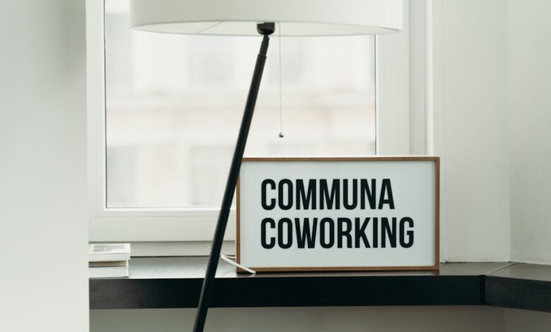 Simple and elegant coworking space decor with soft lamp lighting and window view.