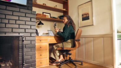 Woman working at a desk in a cozy home office.