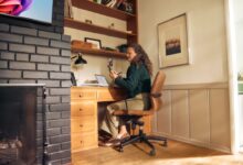 Woman working at a desk in a cozy home office.