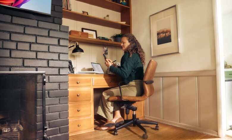 Woman working at a desk in a cozy home office.