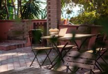 Outdoor patio table with chairs and laptop
