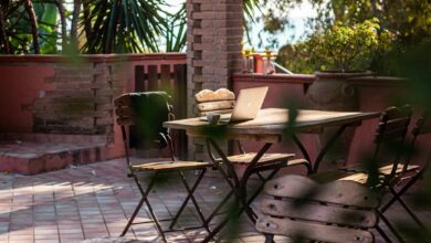 Outdoor patio table with chairs and laptop