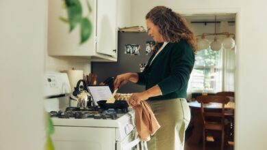Woman cooking on a stovetop in a kitchen