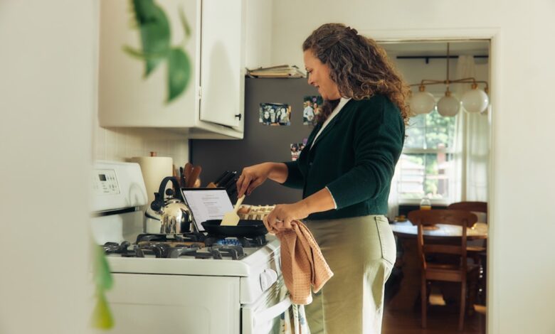 Woman cooking on a stovetop in a kitchen