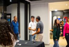 A group of people standing around a table