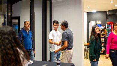 A group of people standing around a table