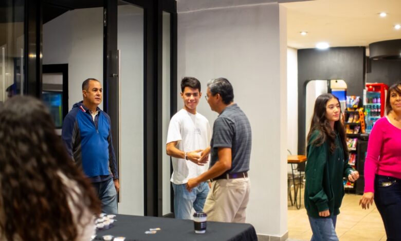 A group of people standing around a table