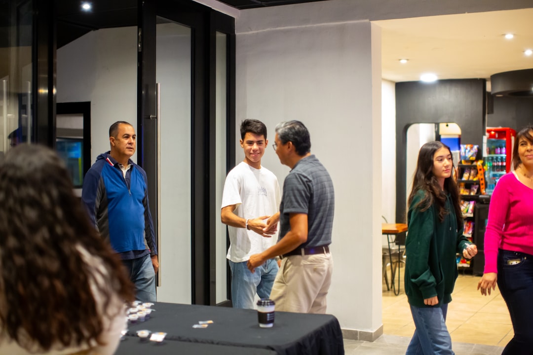 A group of people standing around a table