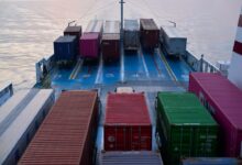 A large boat with lots of containers on it