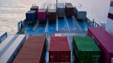 A large boat with lots of containers on it