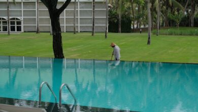 A person cleaning the edge of an infinity pool.
