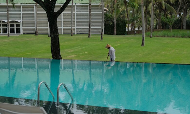 A person cleaning the edge of an infinity pool.