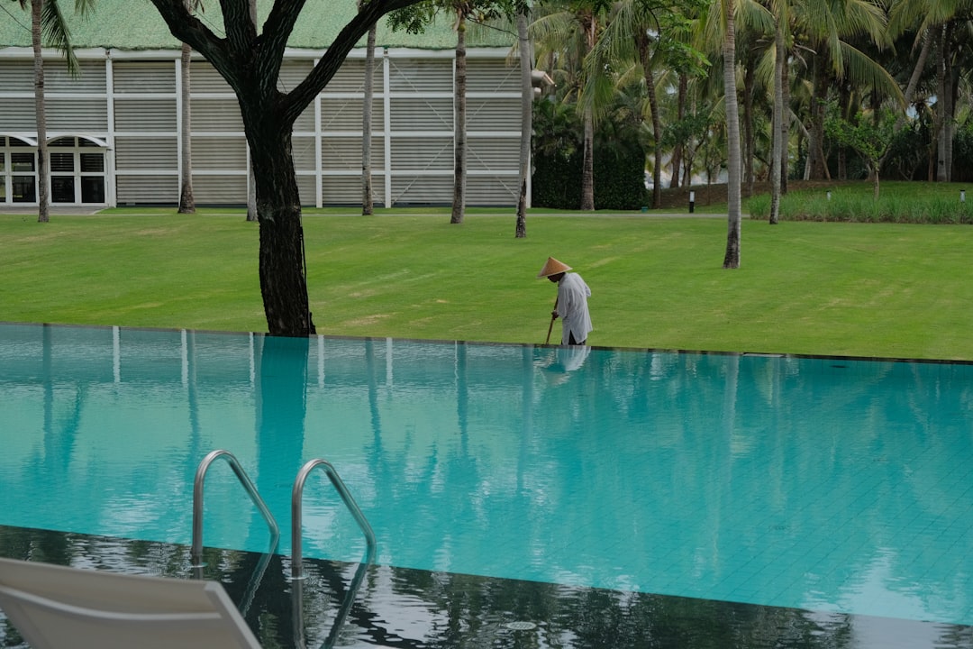 A person cleaning the edge of an infinity pool.