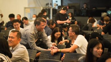 People gathered in a room, some interacting.