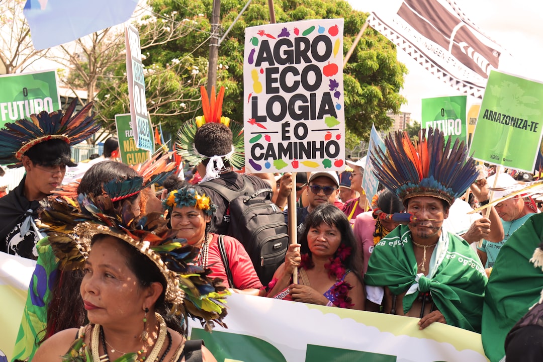 Indigenous people in traditional headdresses at a rally.