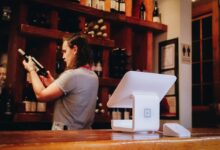woman standing and looking on bottle