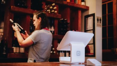 woman standing and looking on bottle