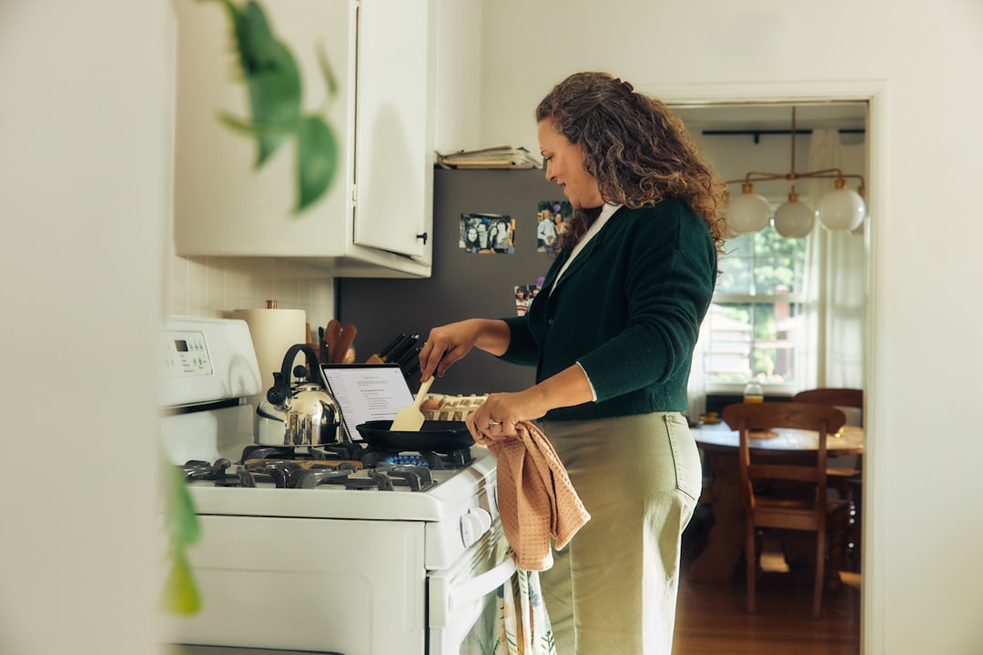 Woman cooking on a stovetop in a kitchen