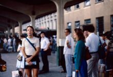 People await transportation at a bustling station.