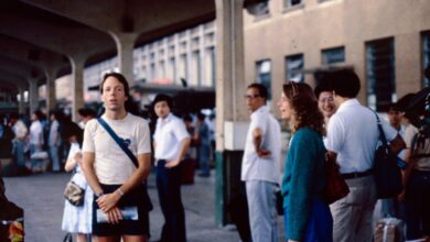 People await transportation at a bustling station.