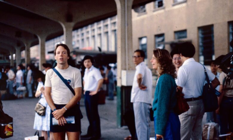 People await transportation at a bustling station.