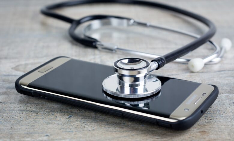 a smart phone with a stethoscope on top of it