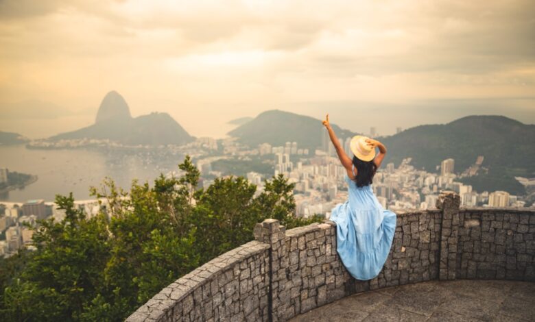 a woman standing on top of a stone wall