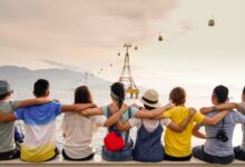 people holding shoulders sitting on wall
