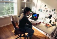 Person working at a desk with a laptop and books.