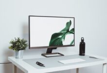 a computer monitor sitting on top of a white desk