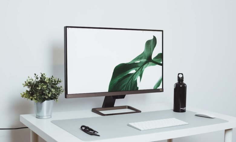 a computer monitor sitting on top of a white desk