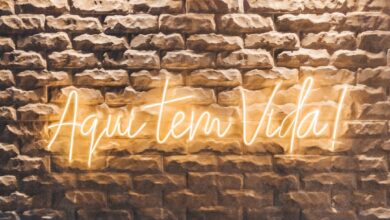 a brick wall with a neon sign on it