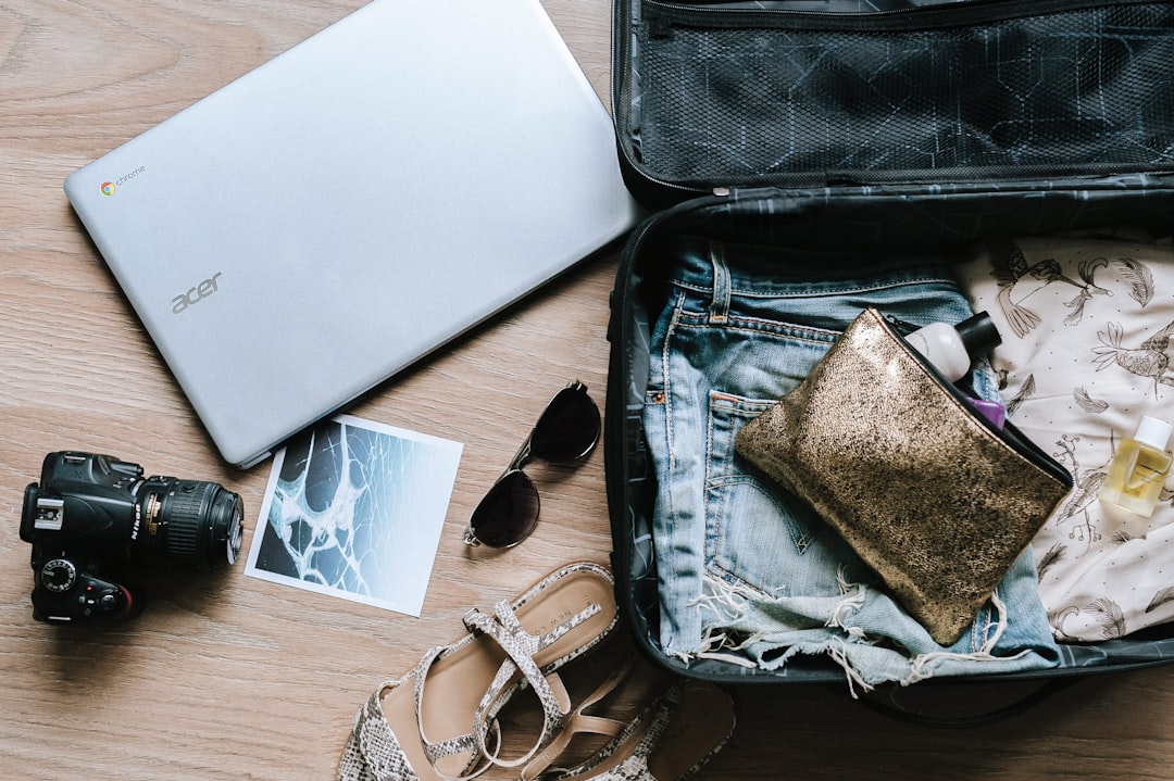 Como Escolher o Destino Ideal para sua Workation - Web Nômade Digital black DSLR camera near sunglasses and bag