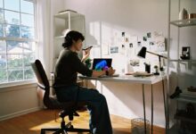 Person working at desk with laptop and phone