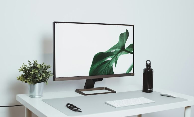 a computer monitor sitting on top of a white desk