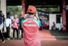 person standing wearing red shirt