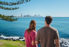 Two people looking at the Gold Coast skyline across the blue ocean