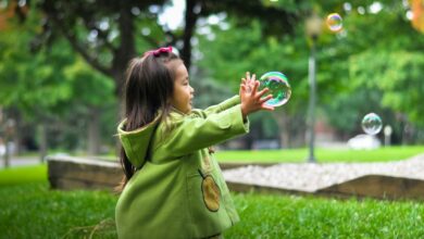 selective photo of a girl holding bubbles