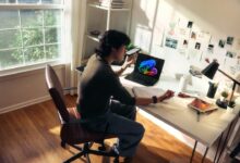Person working at a desk with a laptop and books