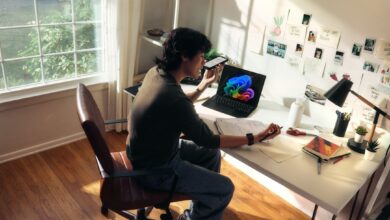 Person working at a desk with a laptop and books