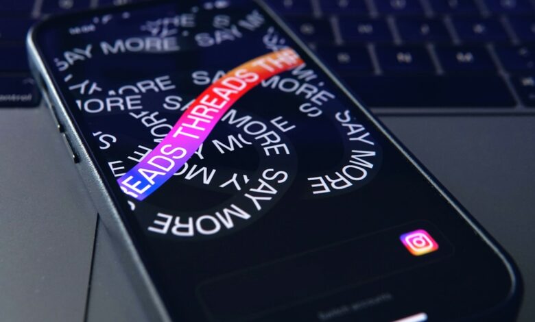 a close up of a cell phone with a keyboard in the background